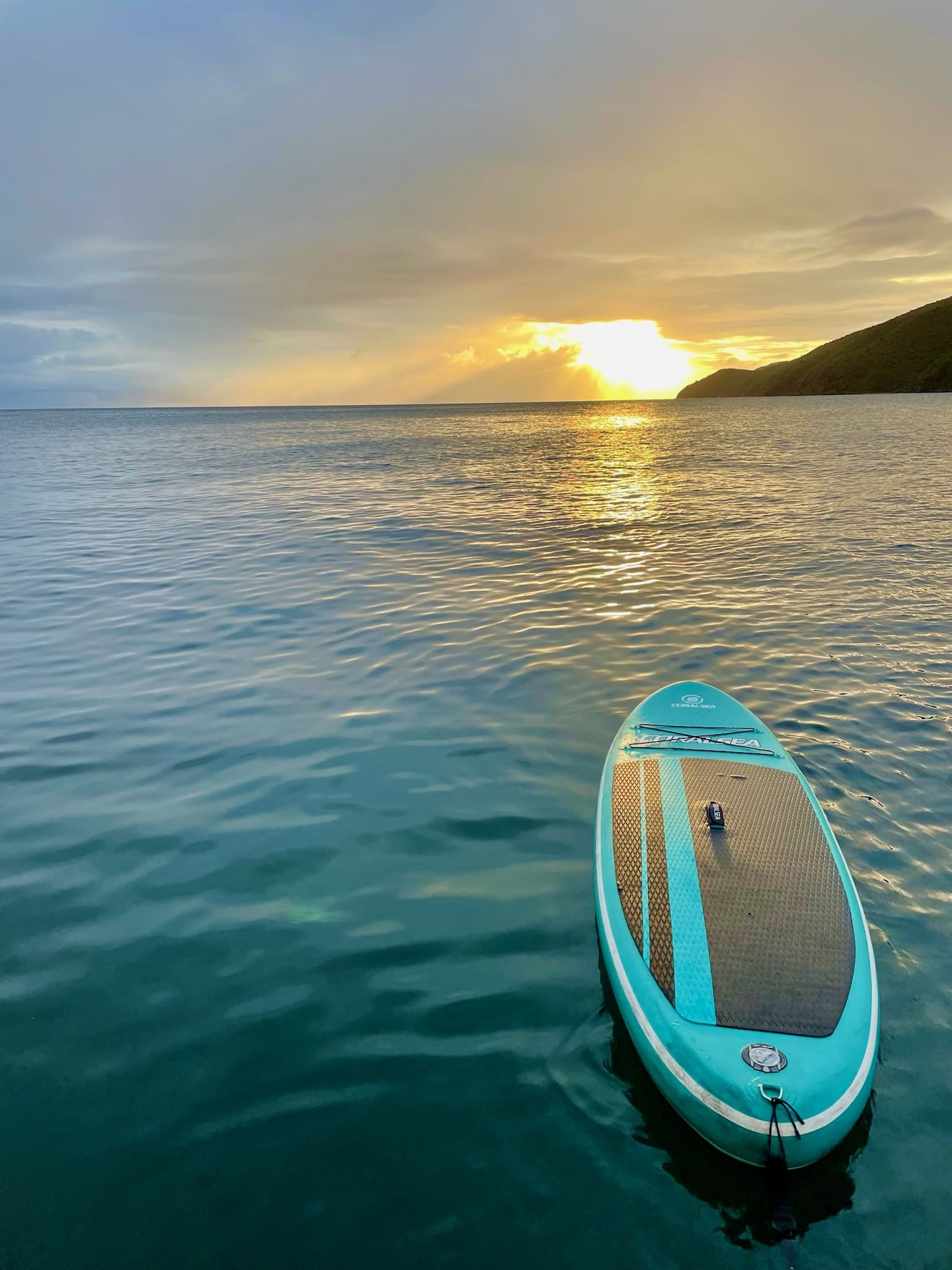 A paddle board in the Caribbean at sunset while on a private catamaran charter