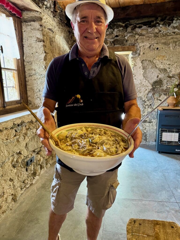 Cooperative member presenting pizzoccheri he had just made in Valtellina Italy